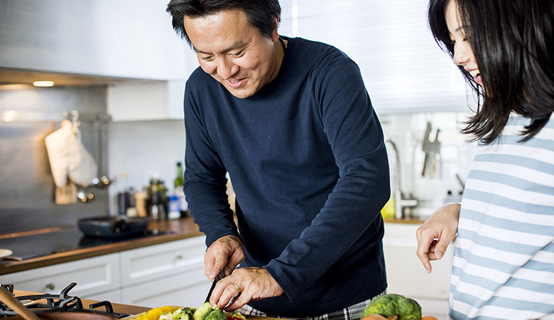 Asian couple cooking in the kitchen